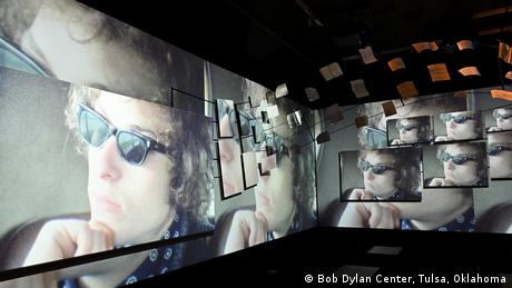 A series of screens showing the same photo of Bob Dylan wearing sunglasses.