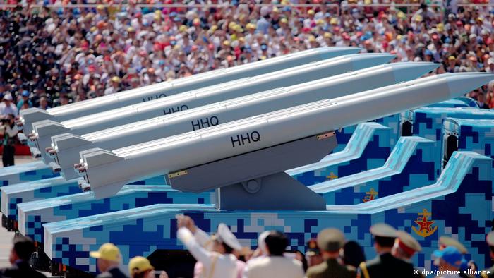 Military vehicles carrying HHQ-9 ship-to-air missiles march past the Tiananmen Rostrum during a military parade