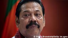 COLOMBO, SRI LANKA - NOVEMBER 11: Acting Prime Minister Mahinda Rajapaksa speaks to members of his party and the media as he formally joins the Sri Lanka Freedom party (SLFP) as the political turmoil continues on November 11, 2018 in Colombo, Sri Lanka. The political crisis started last month when United National Party (UNP) Prime Minister Ranil Wickremesinghe was suddenly replaced with Mahinda Rajapaksa, a controversial former president. Sri Lankan President Maithripala Sirisena dissolved the country's parliament yesterday declaring a snap election on January 5 th. (Photo by Paula Bronstein/Getty Images)