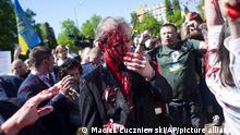 Russian Ambassador to Poland, Ambassador Sergey Andreev is covered with red paint in Warsaw, Poland, Monday, May 9, 2022. Protesters have thrown red paint on the Russian ambassador as he arrived at a cemetery in Warsaw to pay respects to Red Army soldiers who died during World War II. Ambassador Sergey Andreev arrived at the Soviet soldiers cemetery on Monday to lay flowers where a group of activists opposed to Russia’s war in Ukraine were waiting for him. (AP Photo/Maciek Luczniewski)