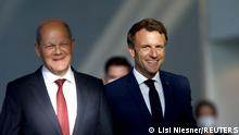 Germany's Chancellor Olaf Scholz and France's President Emmanuel Macron walk to attend a news conference at the Chancellery in Berlin, Germany May 9, 2022. REUTERS/Lisi Niesner