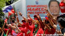 Supporters of presidential candidate Ferdinand Marcos Jr. celebrate as partial results of the 2022 national elections show him with a wide lead over rivals