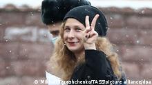 MOSCOW, RUSSIA - MARCH 18, 2021: Maria Alyokhina (R), a member of the Russian punk rock group Pussy Riot, makes a V-sign outside Moscow's Basmanny District Court ahead of a hearing into the investigation's request to extend her house arrest in the case of violation of sanitary-epidemiological rules at the 23 January 2021 unauthorized rally in Moscow. Mikhail Tereshchenko/TASS
