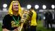 Erling Braut Haaland celebrates with the German Cup in his hands and his shirt pinned on his head. Erling Braut Haaland celebrates with the German Cup in his hands and his shirt pinned on his head.