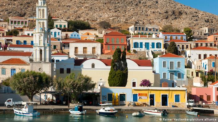 Colorful houses at the port of Halki island, Greece