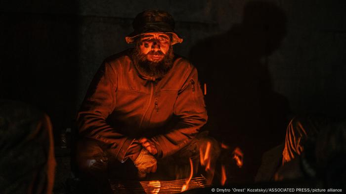 In this photo provided by Ukraine's Azov Regiment, a soldier sits in a steel plant in Mariupol after being injured during fighting with Russian forces