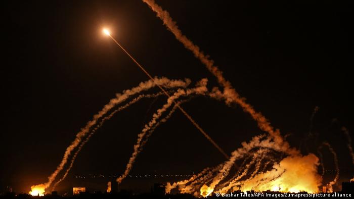 rockets at night shoot across sky