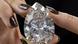 A Christie's employee holds "The Rock" a white diamond of 228.31 carats, the largest white diamond ever seen throughout auction market history, during a preview at Christie's, in Geneva, Switzerland, Friday, May 6, 2022. A Christie's employee holds "The Rock" a white diamond of 228.31 carats, the largest white diamond ever seen throughout auction market history, during a preview at Christie's, in Geneva, Switzerland, Friday, May 6, 2022.