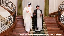 In this photo released by the official website of the office of the Iranian Presidency, President Ebrahim Raisi, right, and Qatari Emir Sheikh Tamim bin Hamad Al Thani arrive for their joint press briefing at the Saadabad Palace in Tehran, Iran, Thursday, May 12, 2022. Qatar's emir arrived in Tehran for talks with the Iranian president as efforts to save Tehran's tattered nuclear deal with world powers hit a deadlock. (Iranian Presidency Office via AP)