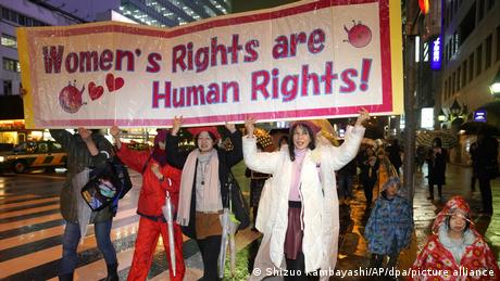 Women in Japan holding a banner on gender rights