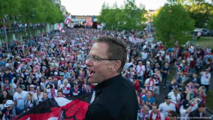 Leipzig's coach and sporting director Ralf Rangnick looks down on a large crowd of RB fans at the RB Leipzig promotion celebration