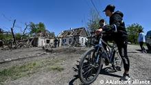 KOMYSHUVAKHA, UKRAINE - MAY 12: Ukrainians inspect damaged houses after the 18 missiles hit the civil settlements of Komyshuvakha, Zaporizhzhia Oblast, Ukraine on May 12, 2022. One person was killed and three others were injured due to the missile attacks, while the bombardment destroyed 60 buildings. Stringer / Anadolu Agency