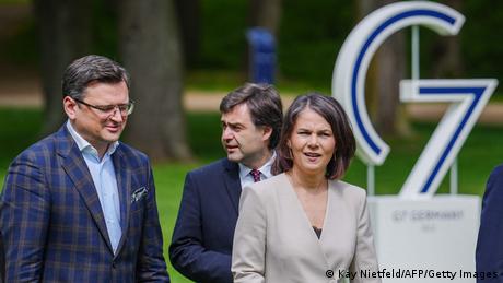 German Foreign Minister Annalena Baerbock walks alongside Ukraine's Foreign Minister Dmytro Kuleba and Moldova's Foreign Minister Nicu Popescu at a G7 meeting in northern Germany