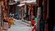 Souvenir shop owners wait for customers at an alley in Bhaktapur, Nepal Souvenir shop owners wait for customers at an alley in Bhaktapur, Nepal