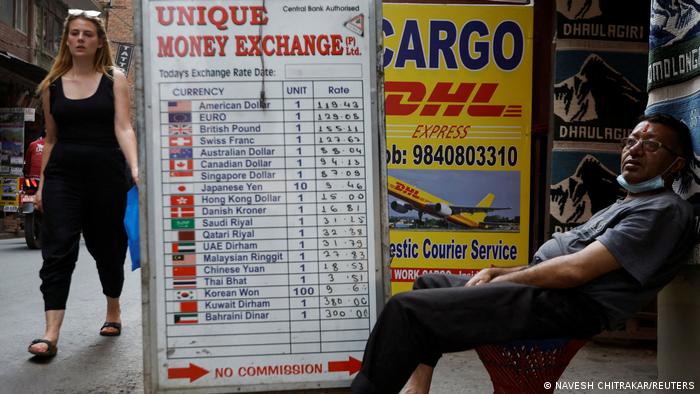 A man sits outside a money exchange at Thamel, a major tourist hub in Nepal