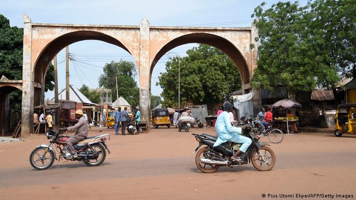 Motor bike riders drive past Kofar Kade, a city gate in ancient Sokoto.