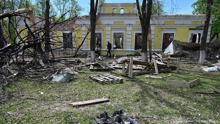  A man walks past a destroyed building of the Hryhoriy Skovoroda National Literary Memorial Museum in the village of Skovorodynivka, in the Kharkiv region