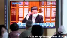 People watch a TV screen showing a file image of North Korean leader Kim Jong Un during a news program at a train station in Seoul, South Korea, Saturday, May 14, 2022. North Korea on Saturday reported 21 new deaths and 174,440 more people with fever symptoms as the country scrambles to slow the spread of COVID-19 across its unvaccinated population. (AP Photo/Ahn Young-joon)
