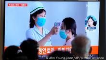 People watch a TV screen showing a news report about the COVID-19 outbreak in North Korea, at a train station in Seoul, South Korea, Saturday, May 14, 2022. North Korea on Saturday reported 21 new deaths and 174,440 more people with fever symptoms as the country scrambles to slow the spread of COVID-19 across its unvaccinated population. (AP Photo/Ahn Young-joon)
