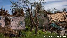 A photograph shows destroyed houses in the village of Vilkhivka, near the eastern city of Kharkiv on May 13, 2022, on the 79th day of the Russian invasion of Ukraine. - Pentagon chief called for 'immediate' ceasefire in Ukraine in call with Russian counterpart on May 13, 2022. (Photo by Dimitar DILKOFF / AFP)