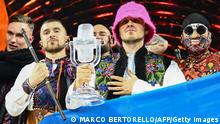 Members of the band Kalush Orchestra pose onstage with the winner's trophy and Ukraine's flags after winning on behalf of Ukraine the Eurovision Song contest 2022 on May 14, 2022 at the Pala Alpitour venue in Turin. (Photo by Marco BERTORELLO / AFP) (Photo by MARCO BERTORELLO/AFP via Getty Images)