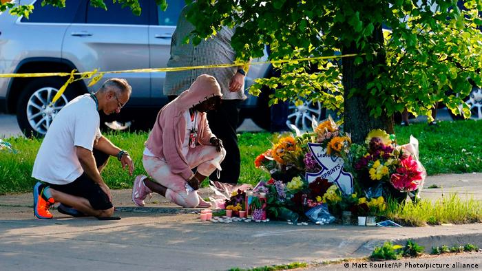 People pay their respects outside the scene of a shooting at a supermarket in Buffalo, New York