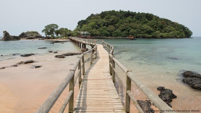 A large wooden bridge over blue waters 