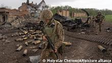 Ukrainian servicemen patrol in a recently retaken village, north of Kharkiv, east Ukraine, Sunday, May 15, 2022. (AP Photo/Mstyslav Chernov)