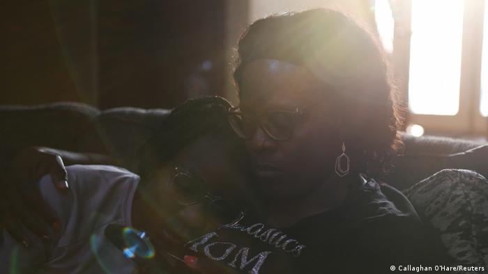Justise McGowan, 13, rests her head on her mother, Dr. Sandra McGowan-Watts, at home in Matteson, Illinois, U.S. March 16, 2022. 