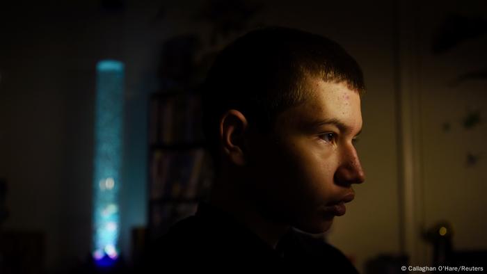 Julius Garza, 14, plays computer games while mourning the loss of his father, who died from the coronavirus disease (COVID-19) in December 2020, in Converse, Texas