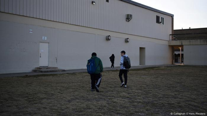Brothers Aidan, 12, (left) and Julius, 14, (right) walk towards Judson Middle School in Converse, Texas