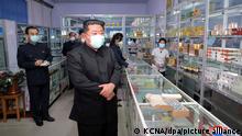 In this photo provided by the North Korean government, North Korean leader Kim Jong Un, center, visits a pharmacy in Pyongyang, North Korea Sunday, May 15, 2022. Independent journalists were not given access to cover the event depicted in this image distributed by the North Korean government. The content of this image is as provided and cannot be independently verified. Korean language watermark on image as provided by source reads: KCNA which is the abbreviation for Korean Central News Agency. (Korean Central News Agency/Korea News Service via AP)
