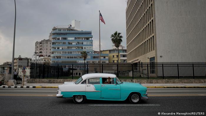 A vintage car passes by the US Embassy in Havana, Cuba.