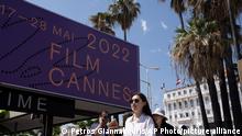 People walk by a festival centre prior to the 75th international film festival, Cannes, southern France, Monday, May 16, 2022.The Cannes film festival runs from May 17th until May 28th 2022. (AP Photo/Petros Giannakouris)