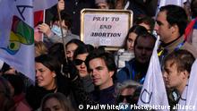 FILE - People take part in a protest against abortion and euthanasia in Madrid, Spain, Sunday, Nov. 28, 2021. The Spanish government approved May 17, 2022 a draft bill that widens abortion rights for teenagers and may make Spain the first country in Europe entitling workers to paid menstrual leave. The Spanish move comes just as the U.S. Supreme Court appears poised to reverse the country's constitutional right to abortion, in place for nearly a half-century. (AP Photo/Paul White, File)