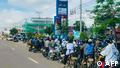 Motorists queueing to pump fuel into their vehicles at a petrol station in Vientiane