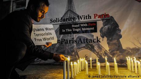 An Afghan civil society activist lights candles to pray for the victims of the 13 November Paris attacks
