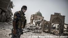 An Iraqi police man stands at the remains of the Al-Nuri mosque, where the Islamic State caliphate was proclaimed, in the old city of Mosul, Iraq, 21 September 2017. After almost nine months of heavy fighting Mosul was declared liberated from the so-called Islamic State in July 2017 leaving its western part mostly reduced to rubble and inhabitable. Photo: Oliver Weiken/dpa
