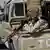 Forces loyal to western Prime Minister Abdul Hamid Dbeibah in Tripoli sit in an army vehicle