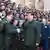 President Xi Jinping shakes hands with a uniformed NUDT officer, other officers nearby