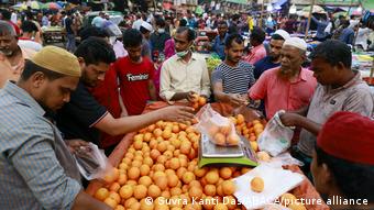 Bangladeshi vendors selling fruits at a market in Dhaka