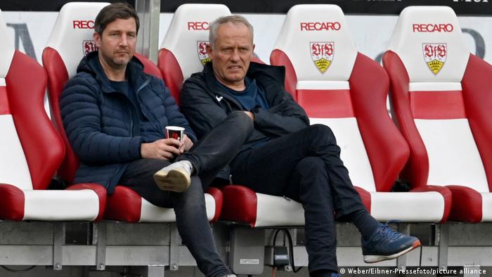 Director of Sport Jochen Saier (left) and head coach Christian Streich sitting together at an away game in Stuttgart.