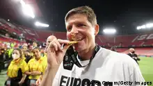 SEVILLE, SPAIN - MAY 18: Oliver Glasner, Head Coach of Eintracht Frankfurt celebrates by biting their UEFA Europa League winners medal following victory in the UEFA Europa League final match between Eintracht Frankfurt and Rangers FC at Estadio Ramon Sanchez Pizjuan on May 18, 2022 in Seville, Spain. (Photo by Alex Grimm/Getty Images)