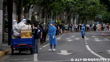 Residents line up for COVID tests on a street during lockdown in Shanghai, China, on May 19, 2022