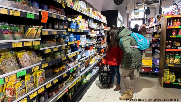 Customers in front of a shelf in a supermarket in Krakow