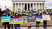 Protesters display signs and flags during a rally marking the one-month anniversary of Russiaâs war in Ukraine. Hundreds of people attended the event at the Lincoln Memorial to support the Ukrainian people in their fight for independence. The rally featured remarks by Ukrainian President Volodymyr Zelenskyy (via video), Ukraineâs Ambassador to the US Oksana Markarova, and former US Ambassador to Ukraine Marie Yovanovitch. Protesters continued their demands for a no-fly zone over Ukraine and expulsion of all Russian banks from the SWIFT system. (Photo by Allison Bailey/NurPhoto)