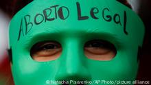 FILE - An abortion-rights activist wears a mask with text that reads in Spanish Legal Abortion during a rally outside Congress as lawmakers debate a bill that would legalize abortion, in Buenos Aires, Argentina, Tuesday, Dec. 29, 2020. In Argentina, lawmakers in late 2020, passed a bill legalizing abortion until the 14th week. (AP Photo/Natacha Pisarenko, File)