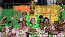 Leipzig players celebrate with the German Soccer Cup trophy at the end of the final match RB Leipzig won against SC Freiburg, and at the Olympic Stadium in Berlin, Germany, Saturday, May 21, 2022. (AP Photo/Michael Sohn)