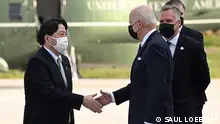 US President Joe Biden is greeted by Japan's Foreign Minister Yoshimasa Hayashi upon arrival in Yokota Air Base in Fussa, Tokyo prefecture on May 22, 2022. (Photo by SAUL LOEB / AFP)