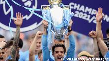 MANCHESTER, ENGLAND - MAY 22: Jack Grealish of Manchester City lifts the Premier League trophy after their side finished the season as Premier League champions during the Premier League match between Manchester City and Aston Villa at Etihad Stadium on May 22, 2022 in Manchester, England. (Photo by Stu Forster/Getty Images)